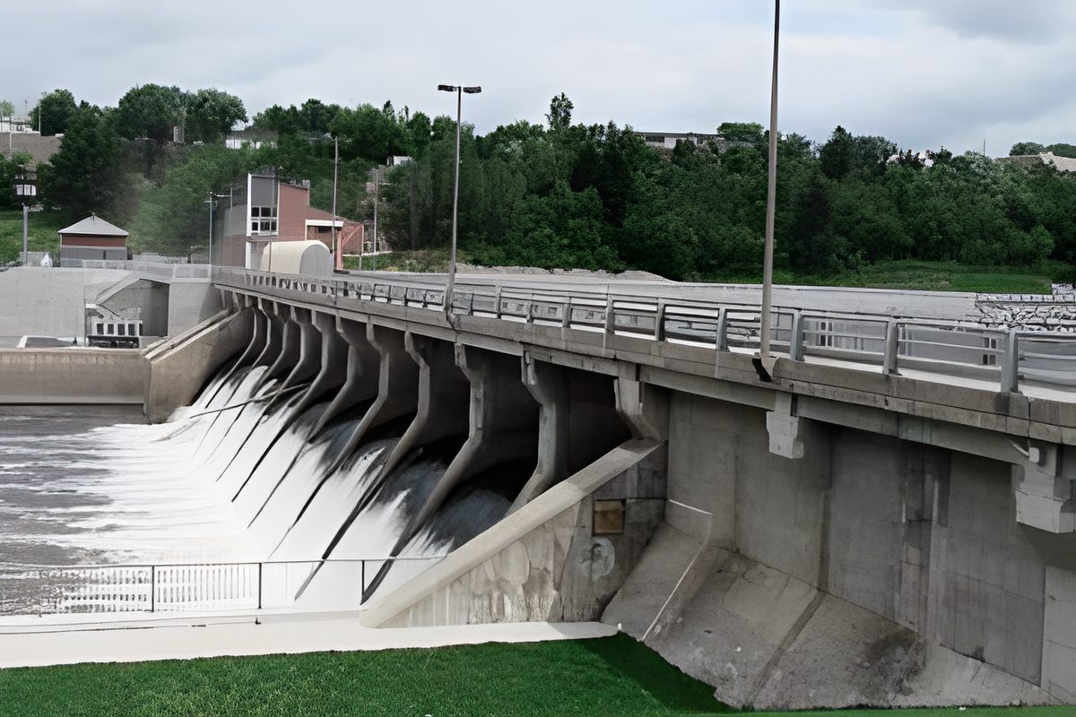 Le barrage Sartigan : la crête de béton et ses vannes, l'eau qui déborde